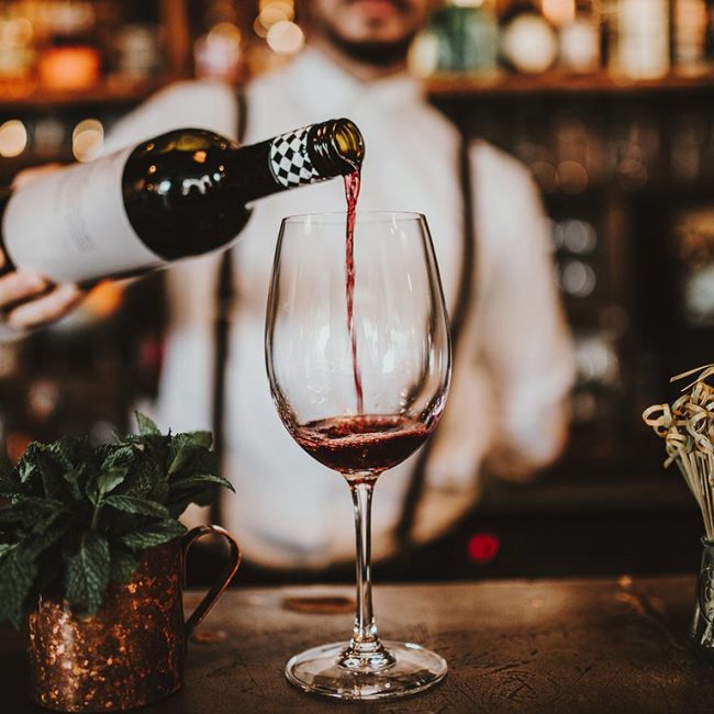 man pouring wine